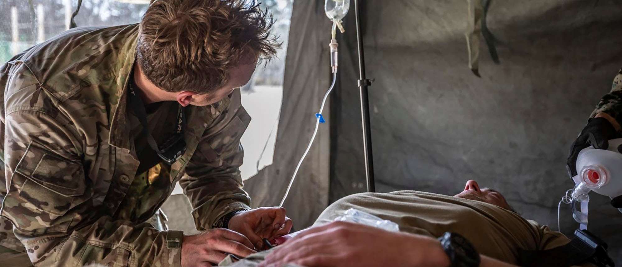 Army medic providing care to a patient