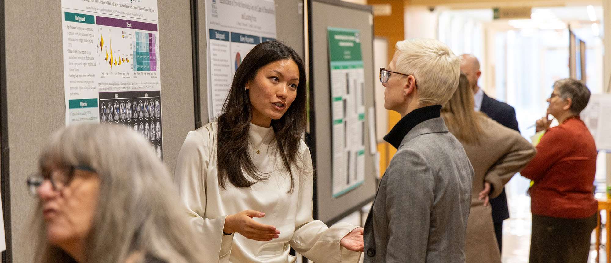 People standing in front of research posters