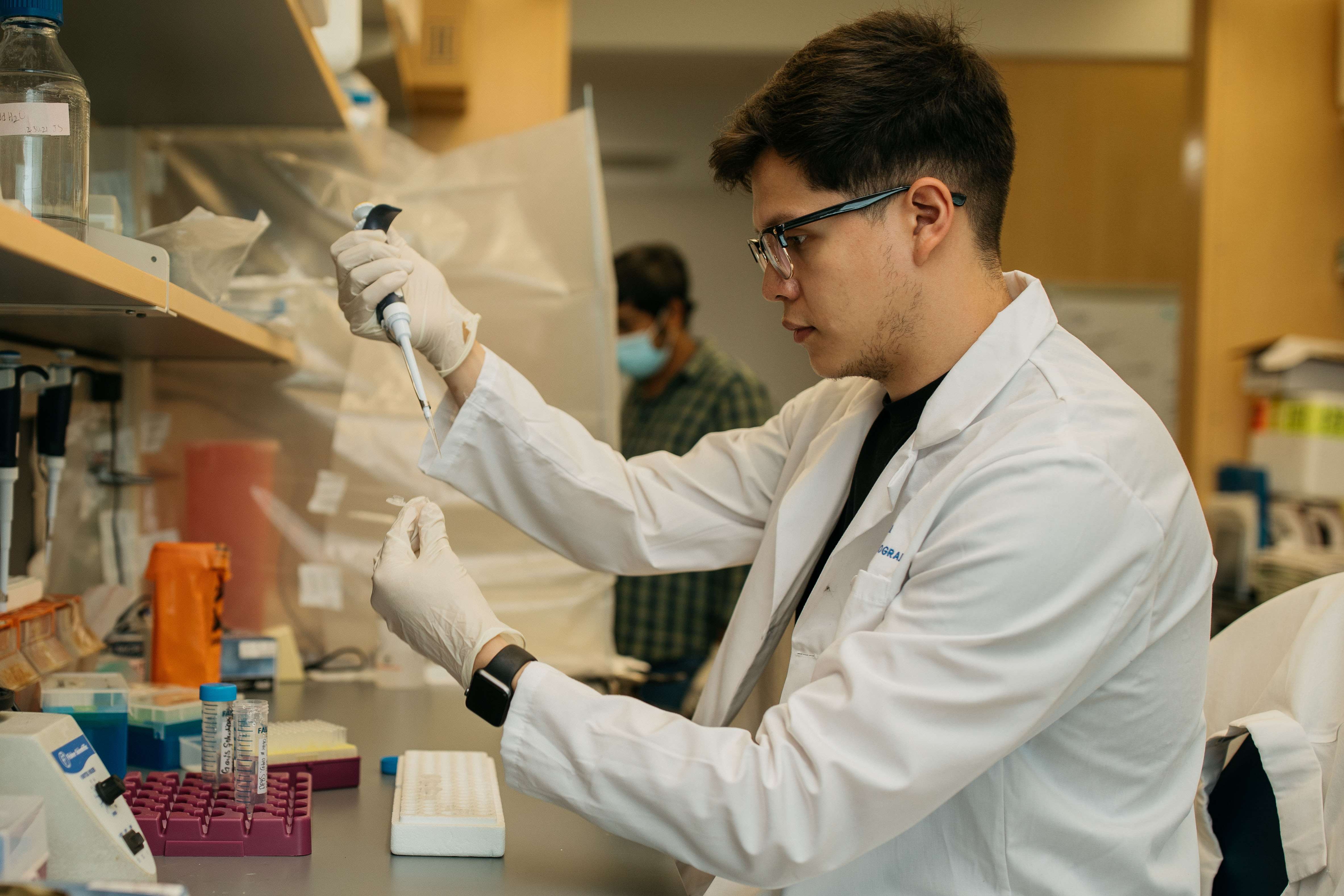 researcher with pipette in laboratory