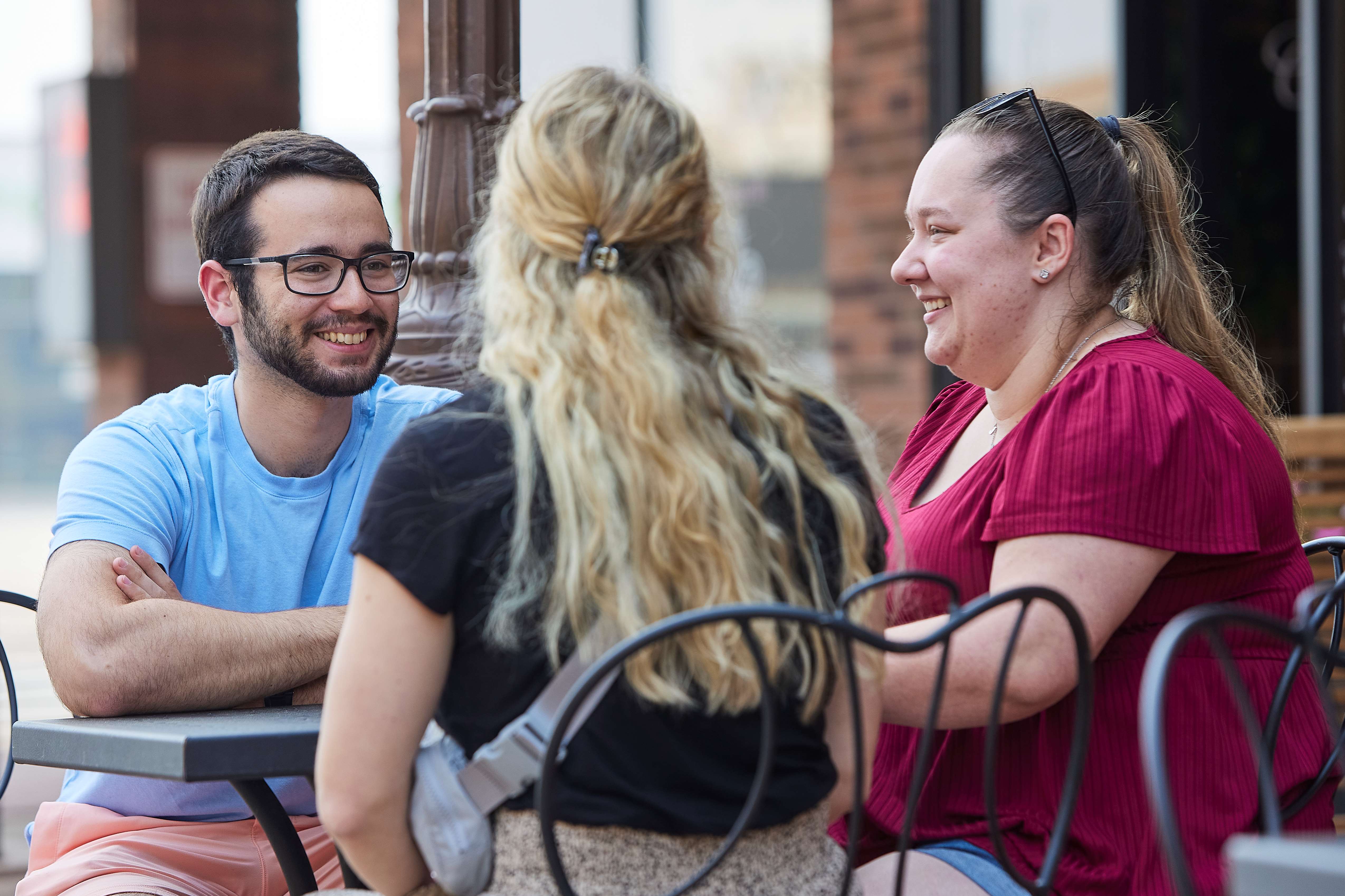 MCW-Central Wisconsin campus medical students talking at table in downtown Wausau WI.